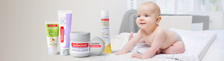 a picture of a baby next to sudocrem products