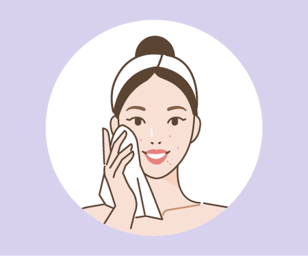 Woman cleaning her face Card image of a woman cleaning her face